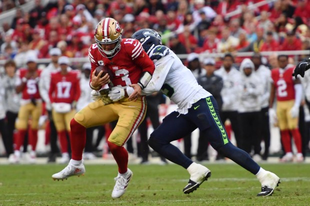 Seattle Seahawks' Ernest Jones IV (13) tackles San Francisco 49ers quarterback Brock Purdy (13) during the fourth quarter of their NFL game at Levi's Stadium in Santa Clara, Calif., on Sunday, Nov. 17, 2024. The Seattle Seahawks defeated the San Francisco 49ers 20-17. (Jose Carlos Fajardo/Bay Area News Group)