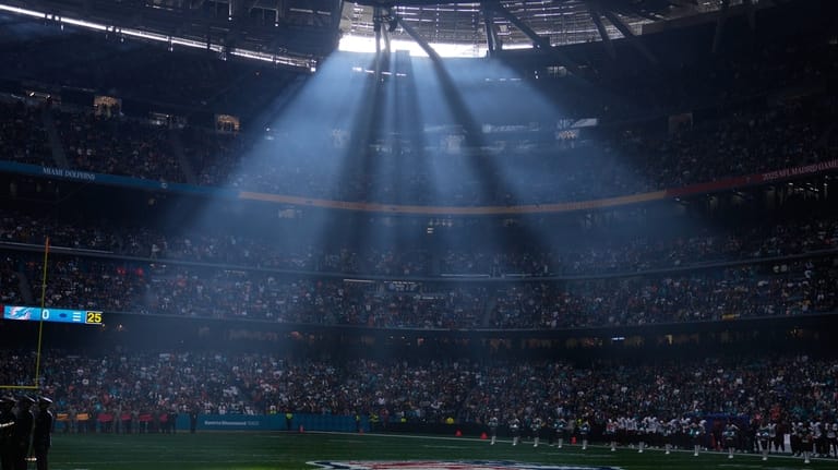 A shaft of sunlight streams into the stadium before an...
