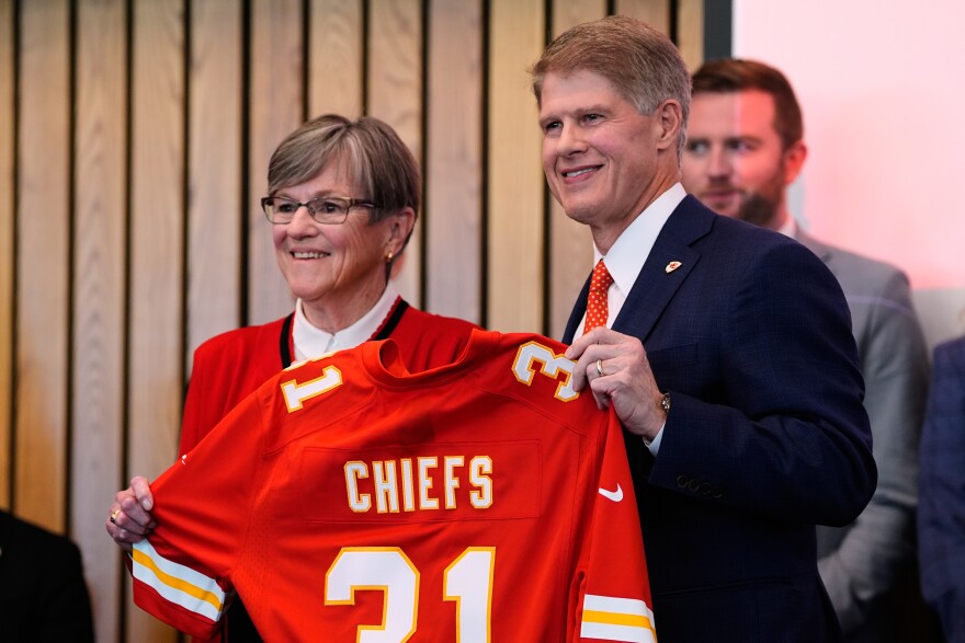 Kansas City Chiefs owner Clark Hunt, right, and Kansas Gov. Laura Kelly, pose for a photo during an event announcing the team will leave Arrowhead Stadium in Kansas City, Mo. for a new stadium that will be built across the Kansas-Missouri state line and be ready for the start of the 2031 season, during an event Monday, Dec. 22, 2025 in Topeka, Kan.
