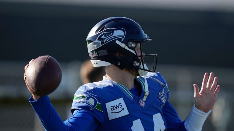Seattle Seahawks quarterback Sam Darnold (14) runs drills during an...