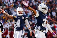 Dallas Cowboys quarterback Dak Prescott (4) and wide receiver George Pickens (3) signal...