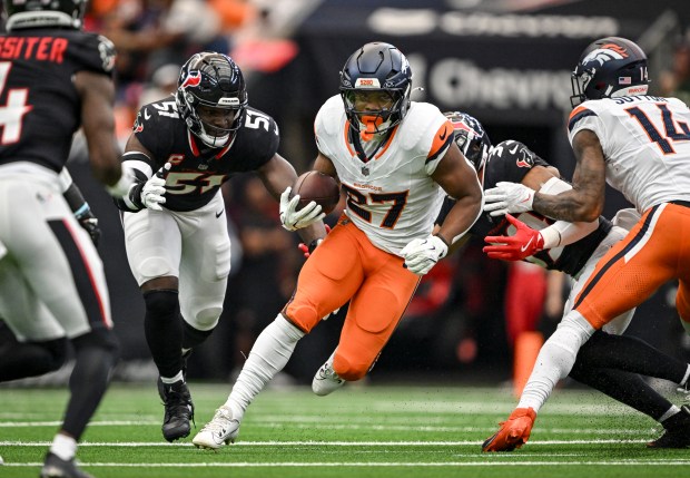 J.K. Dobbins (27) of the Denver Broncos finds space as Will Anderson Jr. (51) of the Houston Texans misses a tackle during the first quarter at NRG Stadium in Houston, Texas on Sunday, Nov. 2, 2025. (Photo by AAron Ontiveroz/The Denver Post)