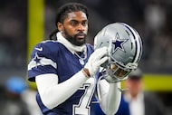 Dallas Cowboys cornerback Trevon Diggs puts on his helmet as the team warms up before an NFL...