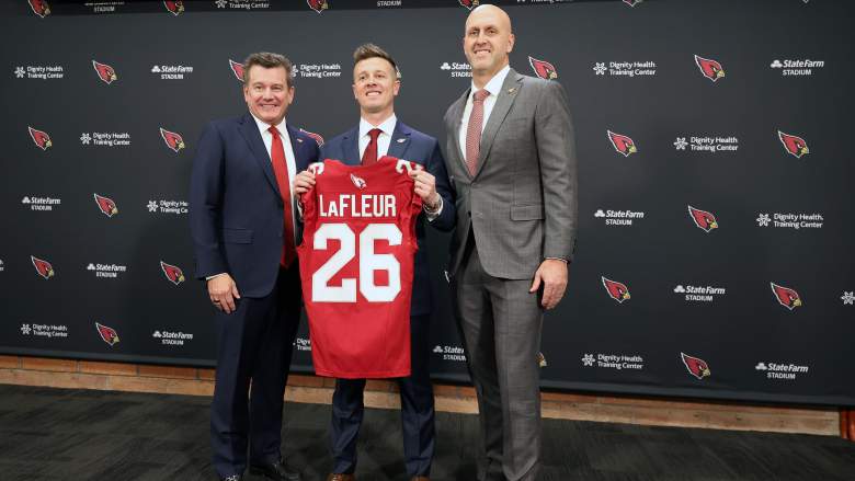 Arizona Cardinals owner Michael Bidwill, head coach Mike LaFleur, and Monti Ossenfort pose with a Cardinals jersey at LaFleur's introductory press conference on February 3, 2026.