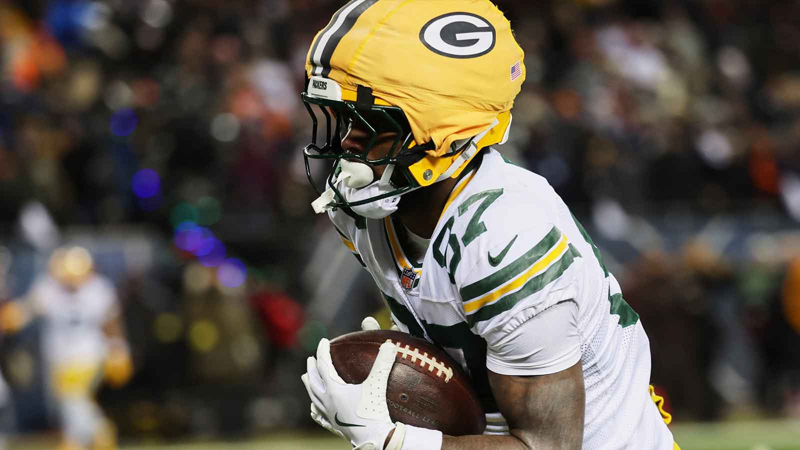 Green Bay Packers wide receiver Romeo Doubs (87) runs for a touchdown after catching a pass thrown by quarterback Malik Willis (not pictured) against the Chicago Bears during the third quarter at Soldier Field.