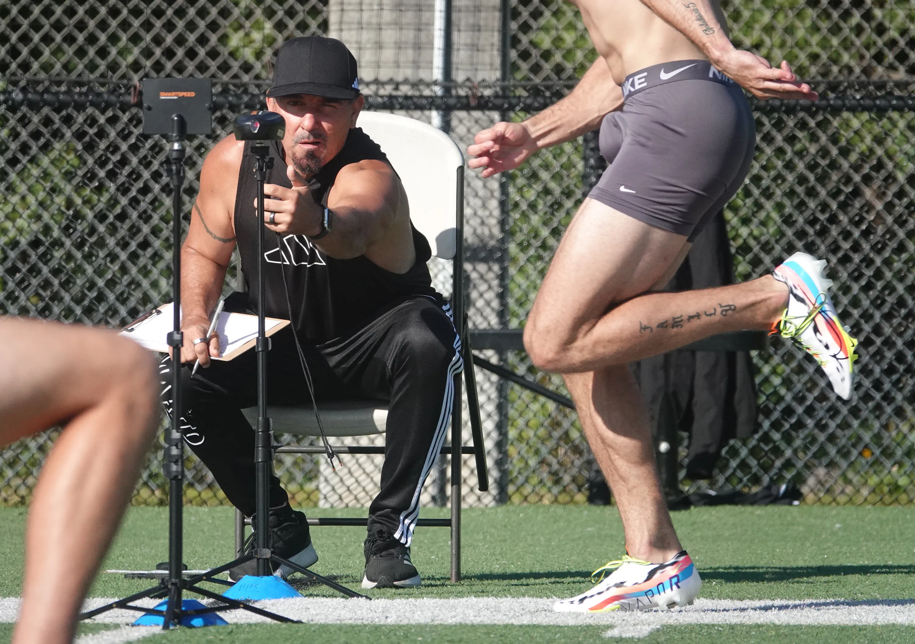 Pete Bommarito times an athlete in the 40-yard dash at...