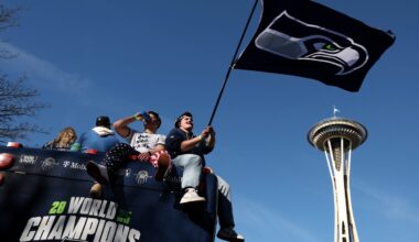 Getty Images logo displayed on a smartphone screen against a background of digital data, representing media and technology...