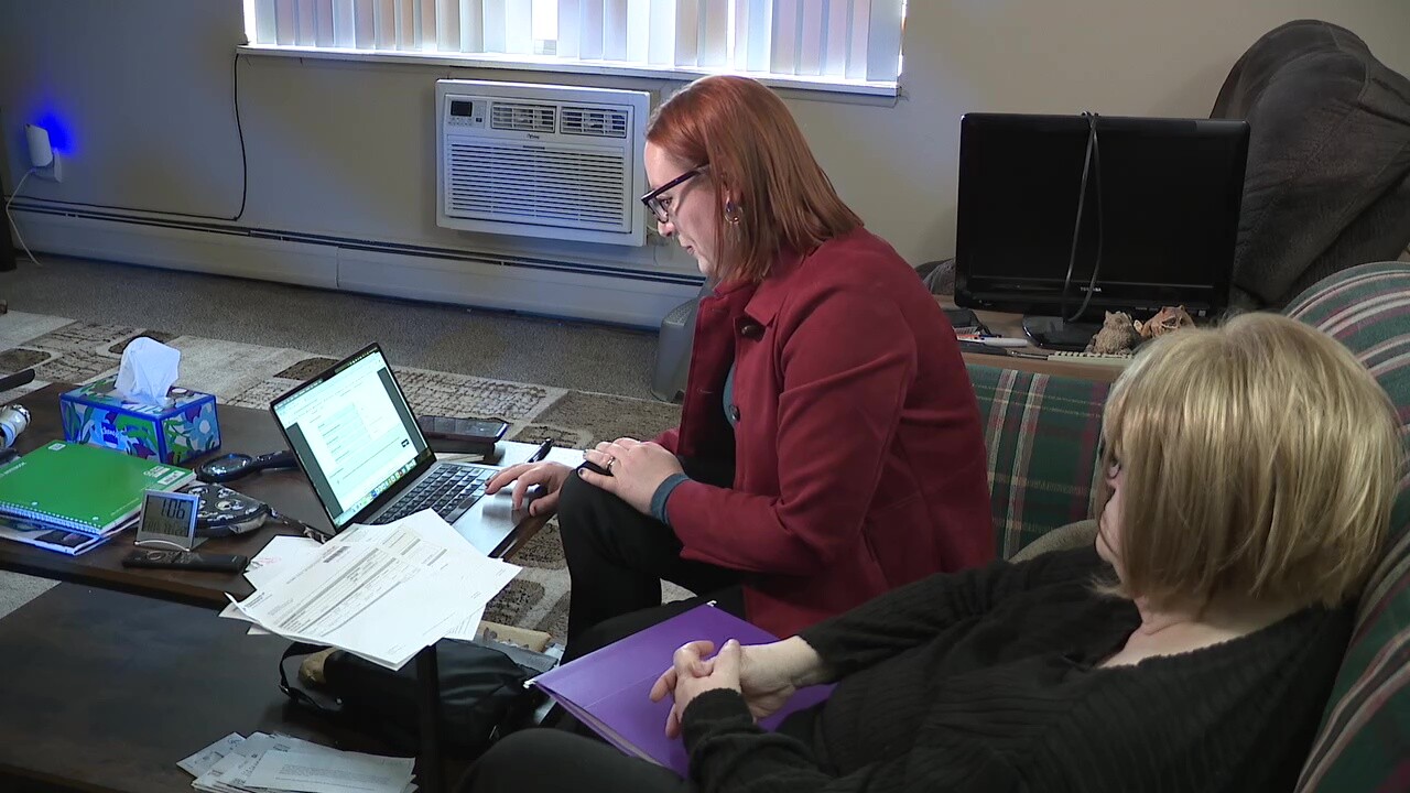 News 5 reporter Michelle Jarboe, center, helps viewer Linda Pietrasz file documents to support her claim for unclaimed funds.