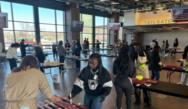 Representatives from all 32 NFL teams build wooden American flags for veterans at Lambeau Field