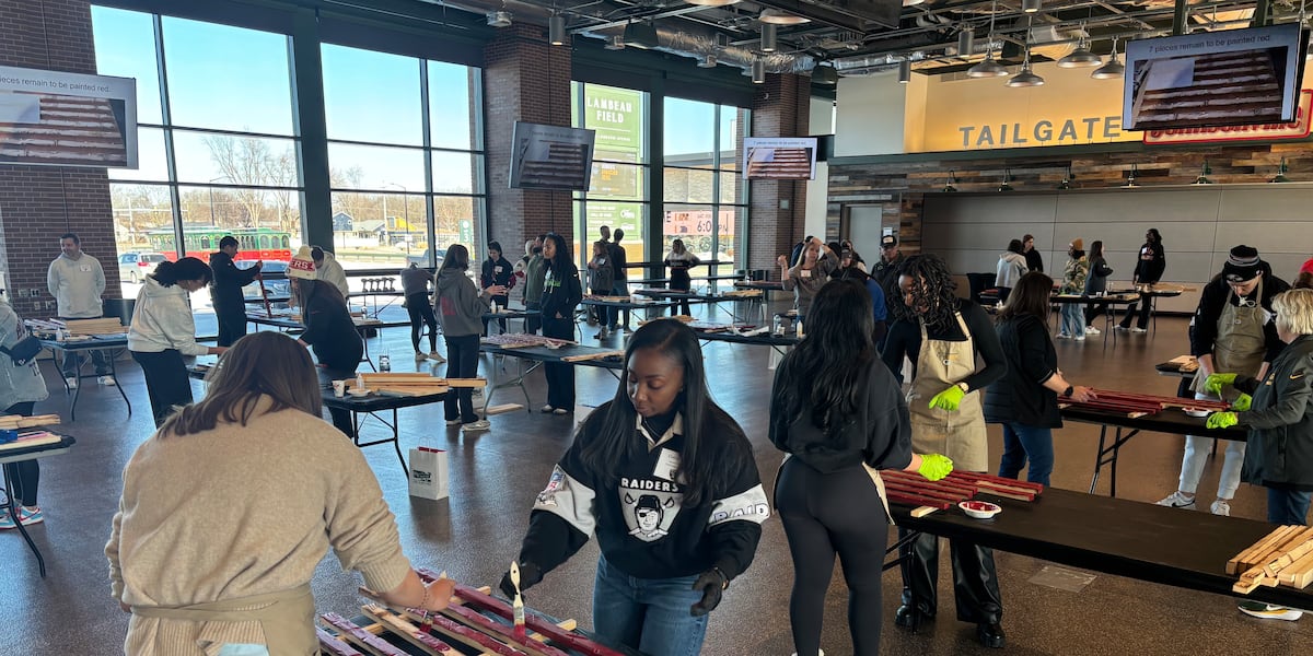 Representatives from all 32 NFL teams build wooden American flags for veterans at Lambeau Field