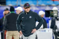 SMU defensive coordinator Scott Symons watches warmups before the ACC championship game...