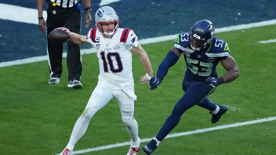 New England Patriots quarterback Drake Maye (10) is pressured by Seattle Seahawks linebacker Boye Mafe