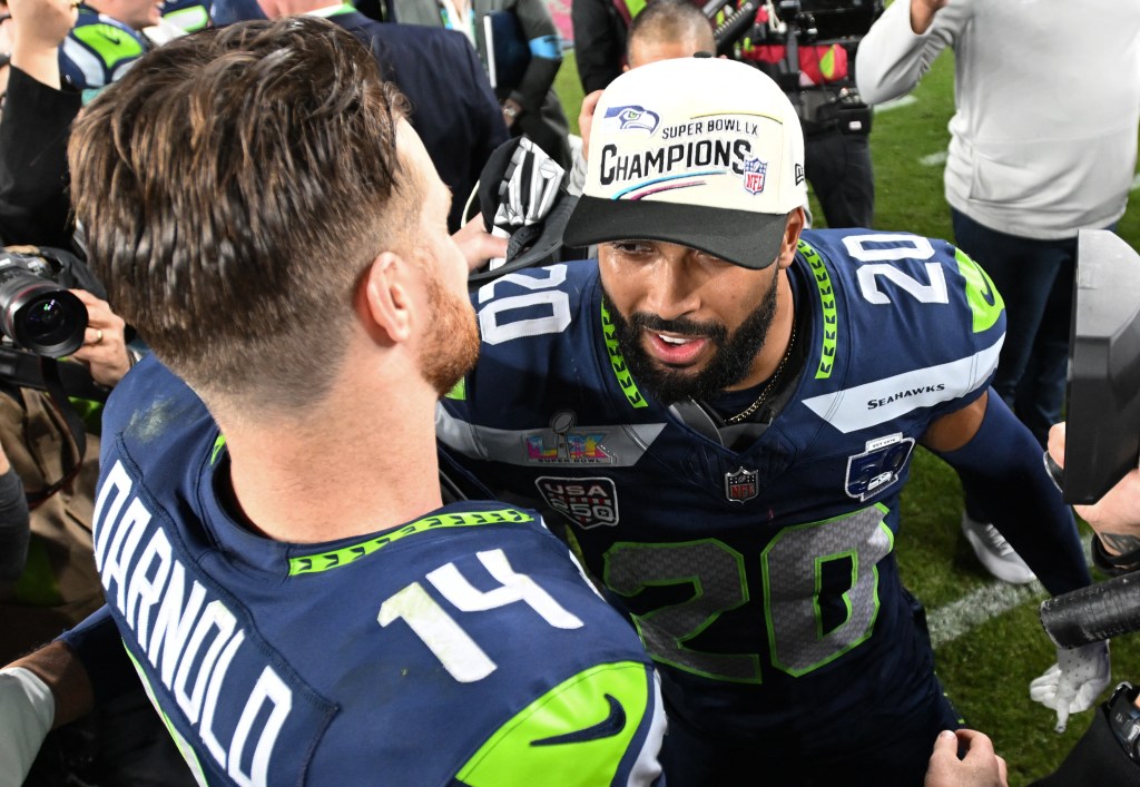 Seattle Seahawks quarterback Sam Darnold and safety Julian Love celebrate their Super Bowl LX victory.