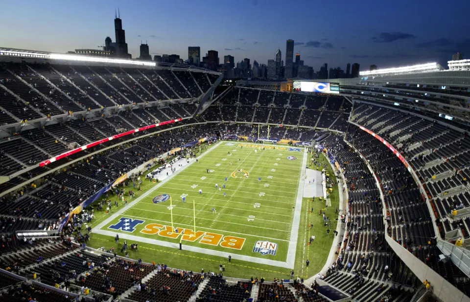 This photo shows a view of the newly renovated Soldier Field, the home of the NFL's Chicago Bears, with the Chicago skyline in the background 29 September, 2003 on opening night of the new stadium as the Chicagp Bears prepare to take on the Green Bay Packers.