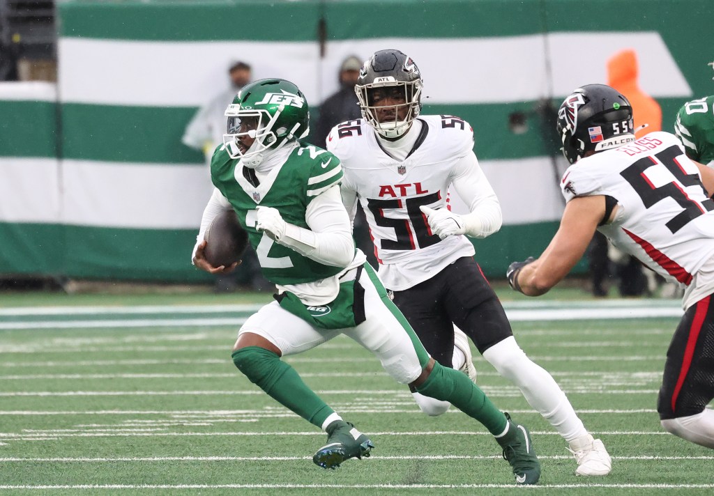 New York Jets quarterback Tyrod Taylor (2) runs the ball as Atlanta Falcons defensive end Leonard Floyd (56) gives chase during the first half when the New York Jets played the Atlanta Falcons Sunday, November 30, 2025 at MetLife Stadium in East Rutherford, NJ. 