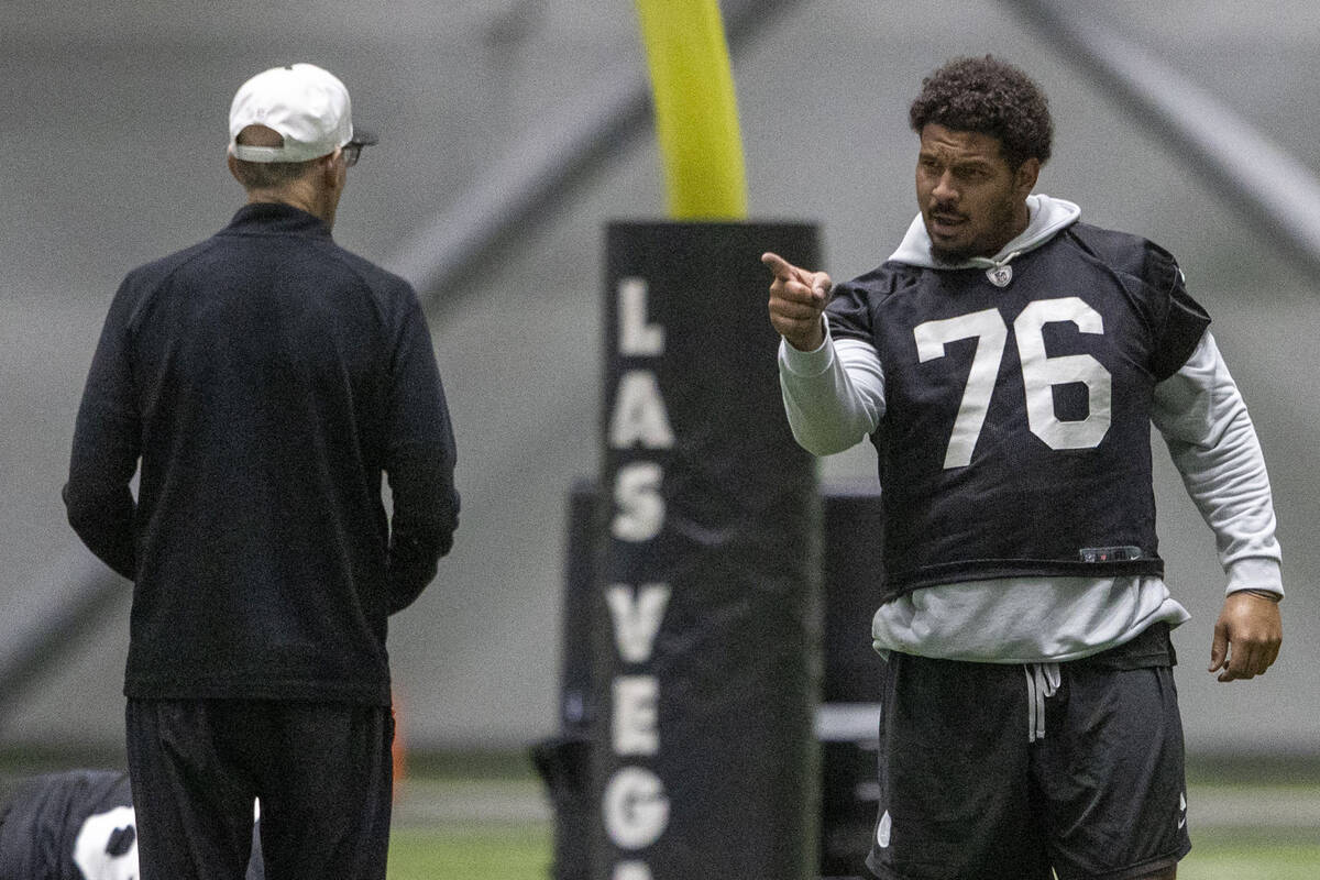 Raiders guard Caleb Rogers (76) points towards senior offensive assistant Joe Philbin during th ...