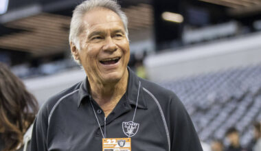 Former Raiders quarterback Jim Plunkett walks on the field before an NFL game between the Raide ...
