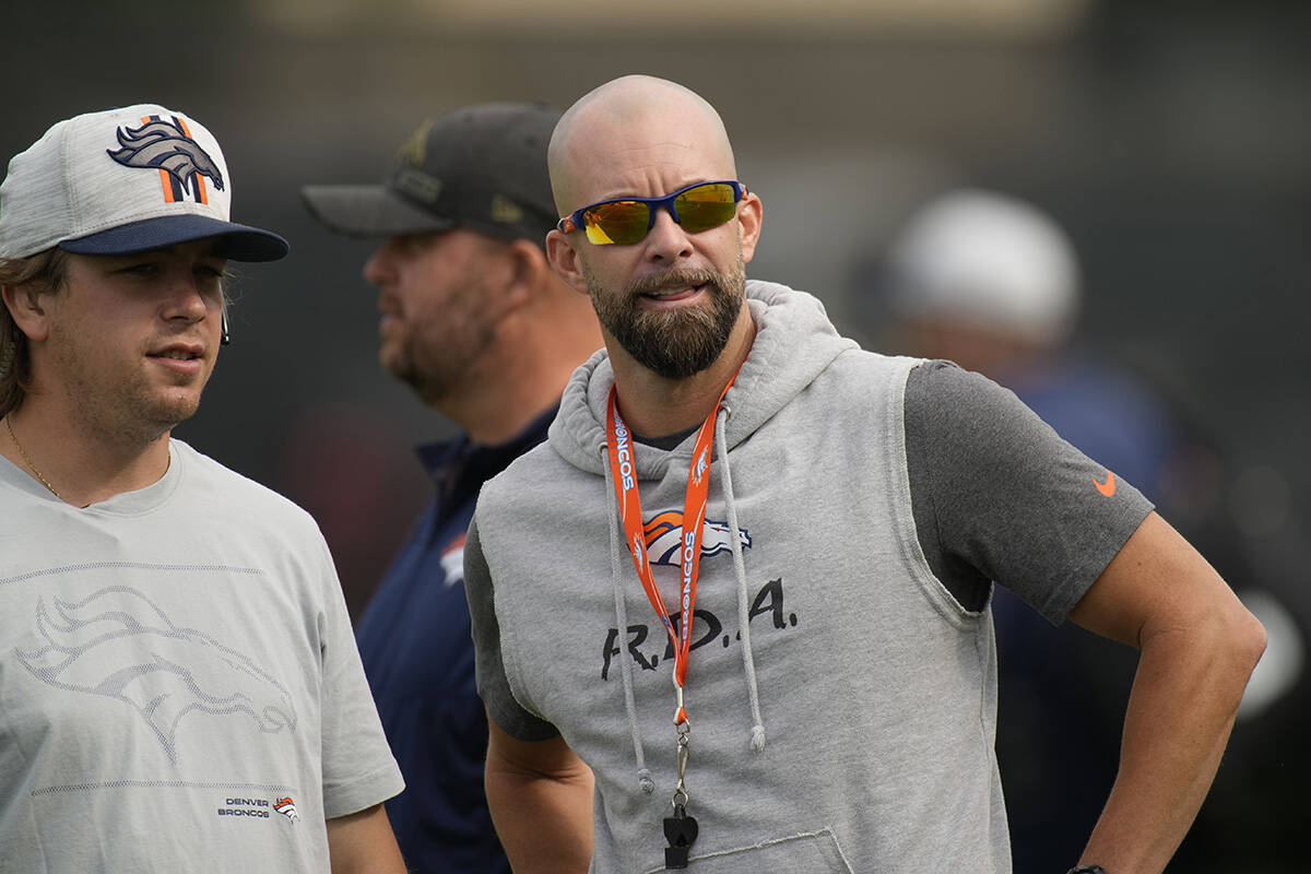 Denver Broncos wide receivers coach Zach Azzanni takes part in drills at an NFL football traini ...