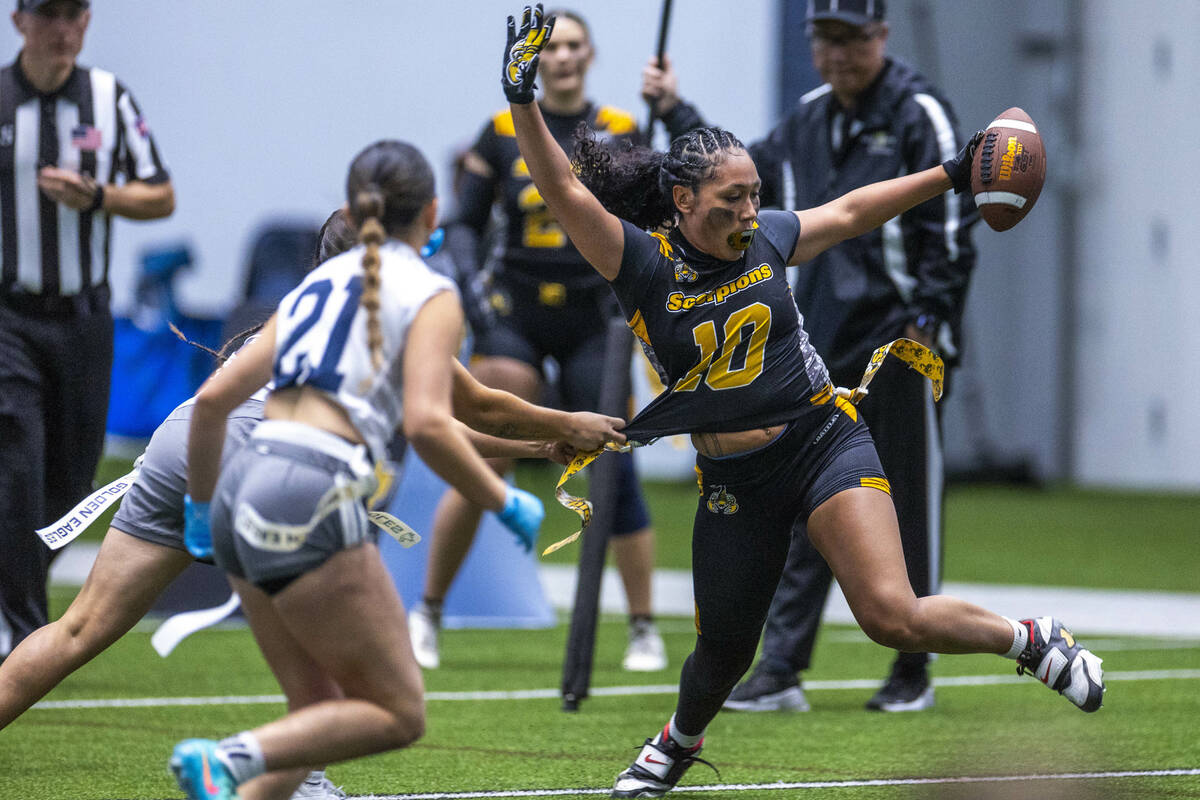 Nevada State's Brooklyn Hill (10) has her flag pulled after an interception and run back b ...