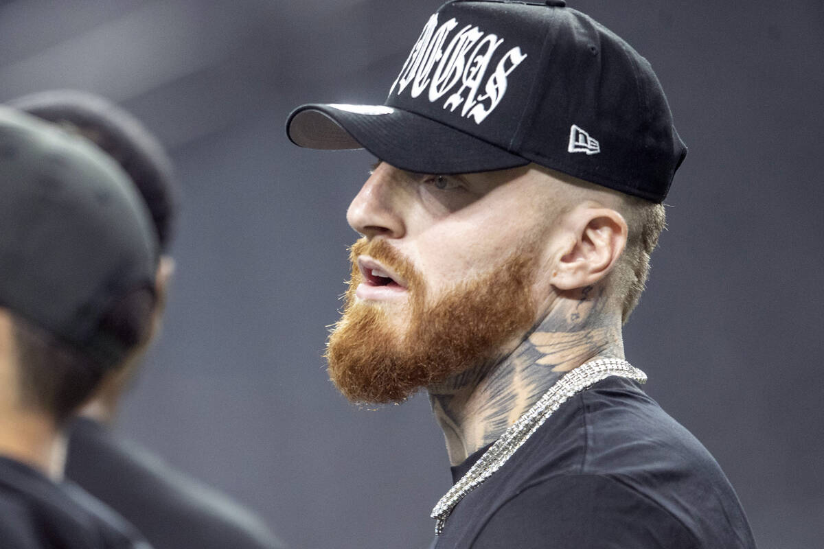 Raiders defensive end Maxx Crosby looks on as the team warms up before an NFL game against the ...