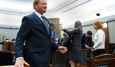 Former Raiders coach Jon Gruden leaves the courtroom after appearing at a hearing at the Region ...