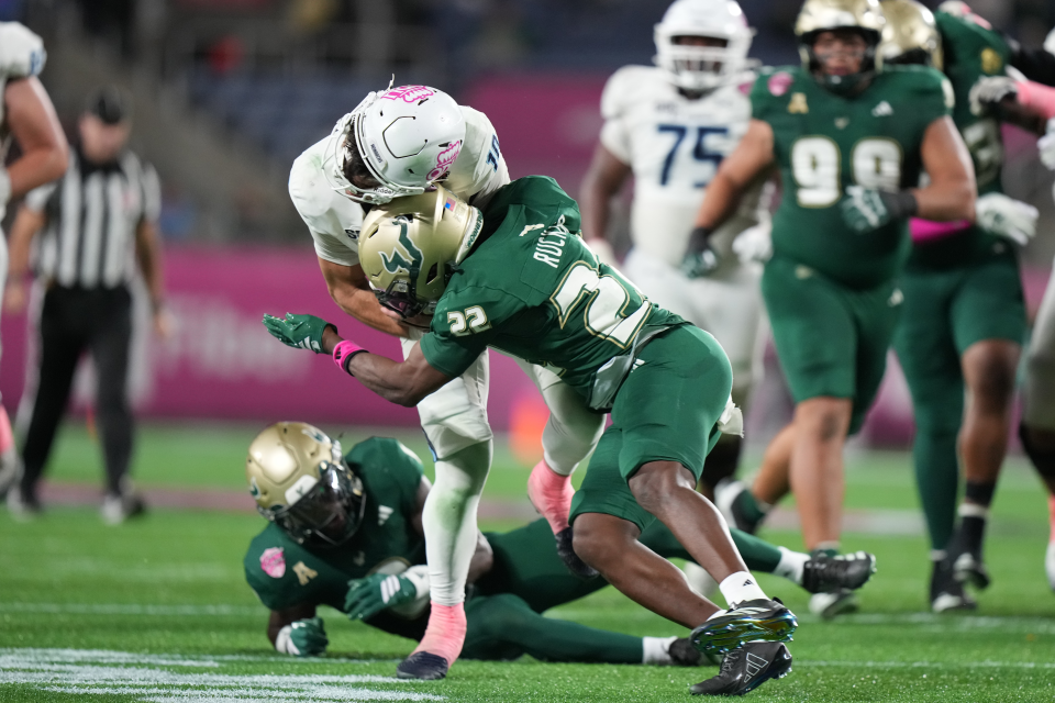 South Florida Bulls cornerback De'Shawn Rucker (22) gets a targeting call for this hit on Old Dominion Monarchs quarterback Quinn Henicle (10) negating a turnover during the StaffDNA Cure Bowl