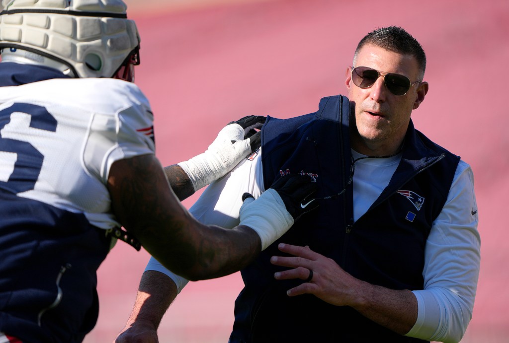 Head coach Mike Vrabel of the New England Patriots participates in drills with his player Morgan Moses #76 during practice prior to Super Bowl LX at Stanford Stadium on February 04, 2026 in Stanford, California.