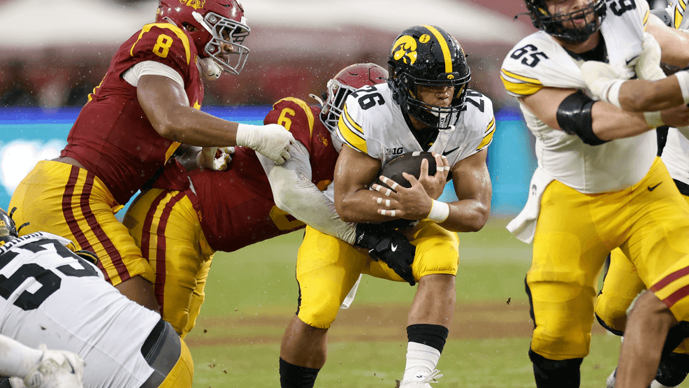 Xavier Williams #26 of the Iowa Hawkeyes is stopped by Anthony Lucas #6 of the Southern California Trojans during a 26-21 Southern California Trojans win at Los Angeles Memorial Coliseum on November 15, 2025 in Los Angeles, California. (Photo by Harry How/Getty Images)