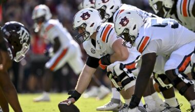 Sep 27, 2025; College Station, Texas, USA; Auburn Tigers offensive lineman Connor Lew (75) sets the ball against the Texas A&M Aggies at Kyle Field. Mandatory Credit: Maria Lysaker-Imagn Images