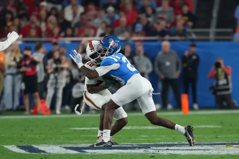Nick Cull #29 of the Ole Miss Rebels hits Malachi Toney #10 of the Miami Hurricanes hard after a reception and the play is reviewed for a targeting call during the Miami Hurricanes versus Ole Miss Rebels College Football Playoff Semifinal
