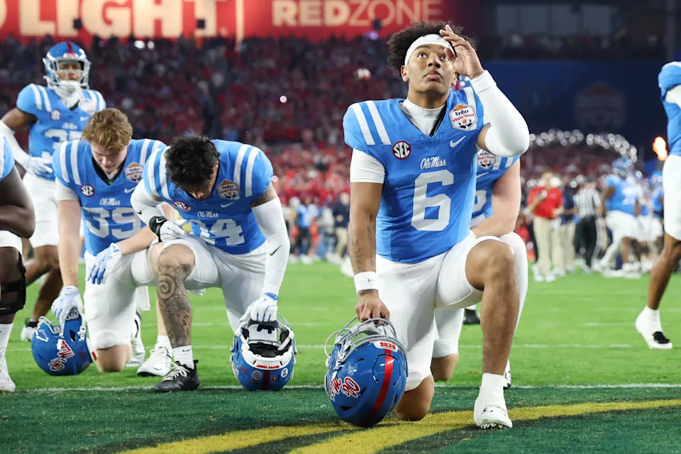 GLENDALE, ARIZONA - JANUARY 08: Trinidad Chambliss #6 of the Ole Miss Rebels takes a knee prior to the CFP Semifinal Vrbo Fiesta Bowl against the Miami Hurricanes at State Farm Stadium on January 08, 2026 in Glendale, Arizona. (Photo by CFP/Getty Images)