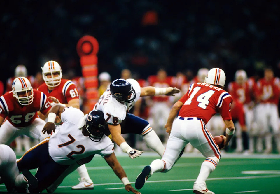 Jan 26, 1986; New Orleans, LA, USA; FILE PHOTO; Chicago Bears defensive tackles (72) William Perry and (76) Steve McMichael chase New England Patriots quarterback (14) Steve Grogan during Super Bowl XX at the Superdome. The Bears defeated the Patriots 46-10. Mandatory Credit: Photo By Malcolm Emmons- USA TODAY Sports © Copyright Malcolm Emmons
