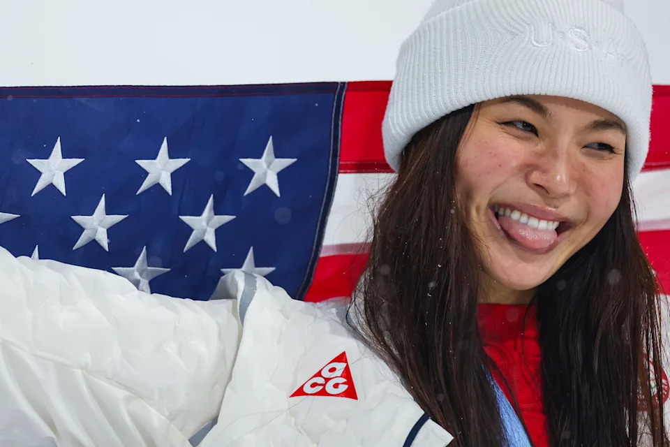 Silver medalist Chloe Kim of Team United States celebrates with the national flag of the United States.