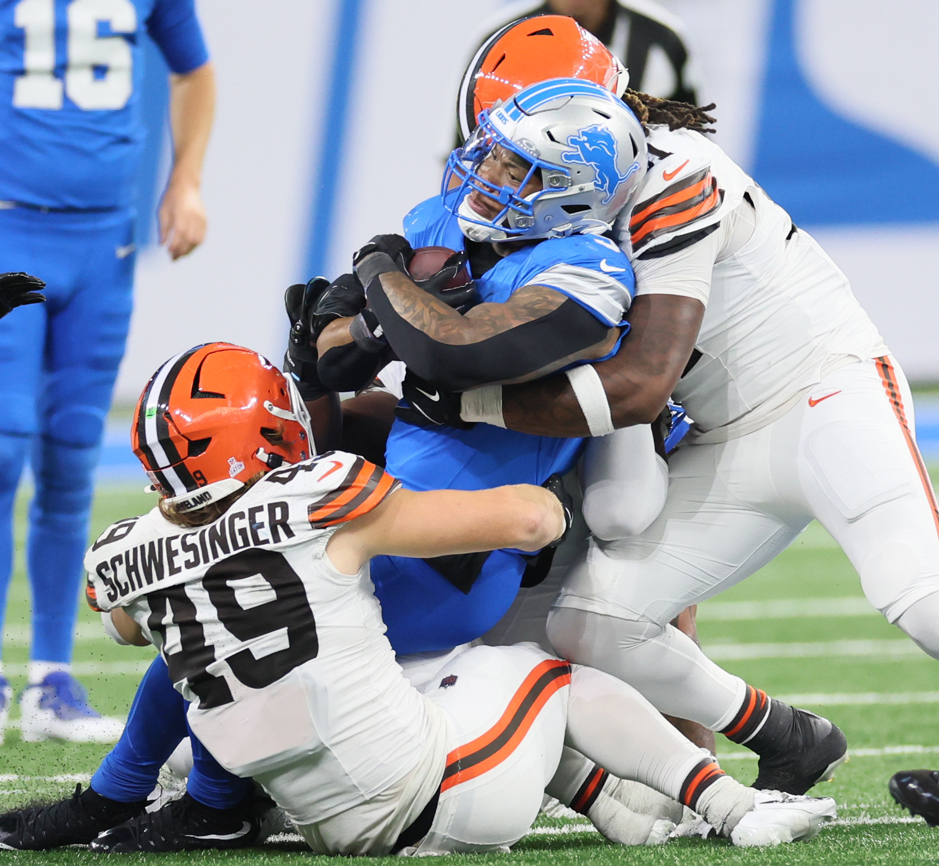 Cleveland Browns linebacker Carson Schwesinger (L) and Cleveland Browns defensive end Alex Wright team up to tackle Detroit Lions running back David Montgomery for a short gain in the second half.  