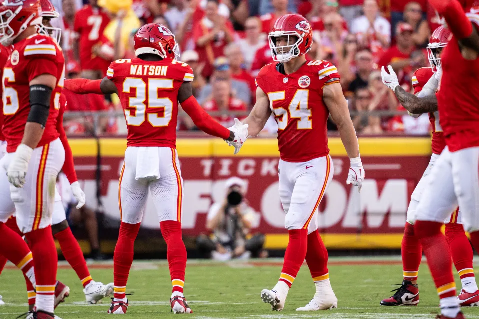Jaylen Watson #35 of the Kansas City Chiefs and Leo Chenal #54 of the Kansas City Chiefs high five after a play during the first half of the game against the Baltimore Ravens