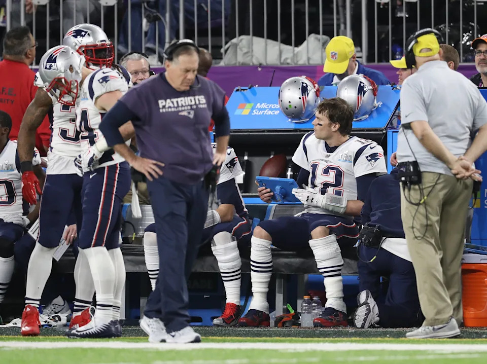 Feb 4, 2018; Minneapolis, MN, USA; New England Patriots quarterback Tom Brady (12) reviews plays on a tablet as head coach Bill Belichick walks the sidelines during the game against the Philadelphia Eagles in Super Bowl LII at U.S. Bank Stadium. Mandatory Credit: Matthew Emmons-USA TODAY Sports
