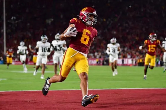 Sep 20, 2025; Los Angeles, California, USA; Southern California Trojans wide receiver Makai Lemon (6) runs the ball for a touchdown against the Michigan State Spartans during the first half at the Los Angeles Memorial Coliseum. Mandatory Credit: Gary A. Vasquez-Imagn Images