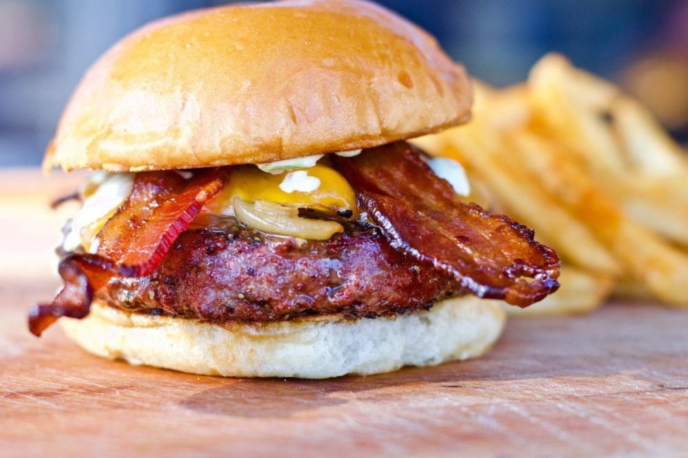 The new space comes with a built-in wood-fired pizza oven, prompting the menu expansion and name change. (Courtesy Tejas Burger Joint)