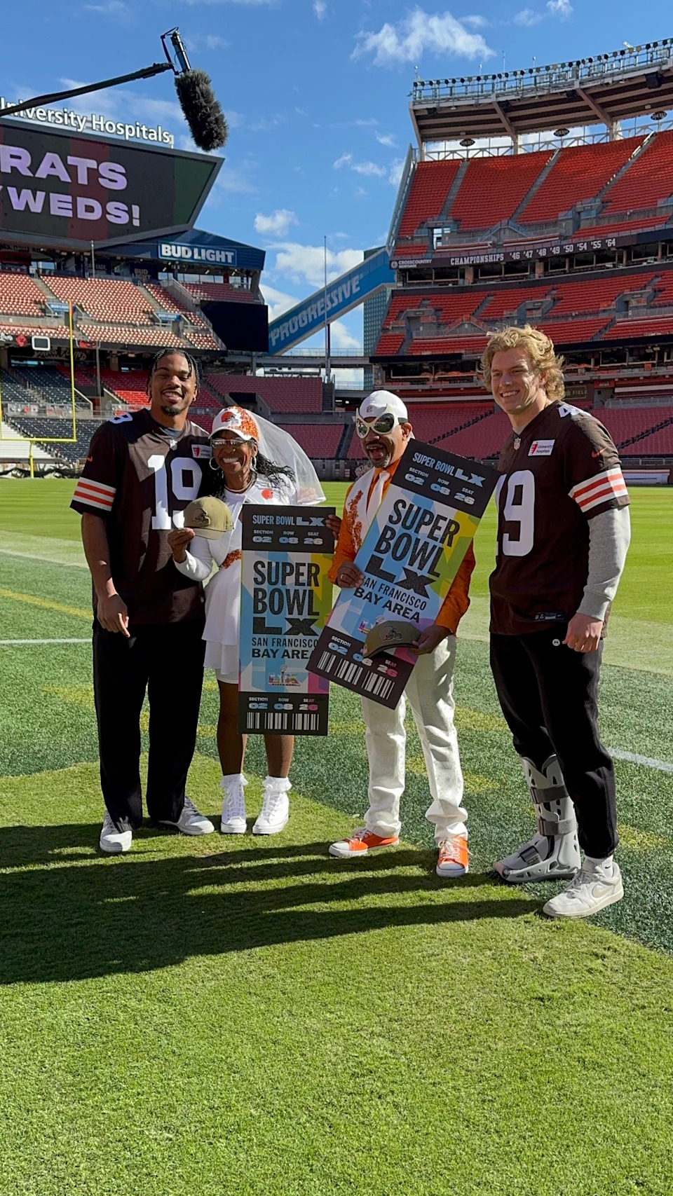 DeSiree "FirstLady" Wheeler and Charles "Brownspider" Bevel Jr. receive Super Bowl LX tickets from Cleveland Browns linebacker Carson Schwesinger and wide receiver Cedric Tillman in October 2025 at Huntington Bank Field.