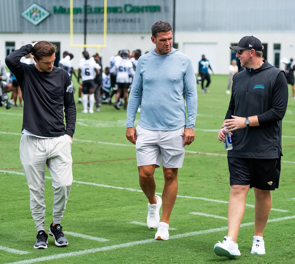 Jacksonville Jaguars general manager James Gladstone, left, Jacksonville Jaguars is executive vice president of football operations Tony Boselli, center and Jacksonville Jaguars head coach Liam Coen, right, all talk on the field after the Jacksonville Jaguars’ mandatory minicamp Tuesday June 10, 2025 at the Miller Electric Center in Jacksonville, Fla. [Doug Engle/Florida Times-Union]