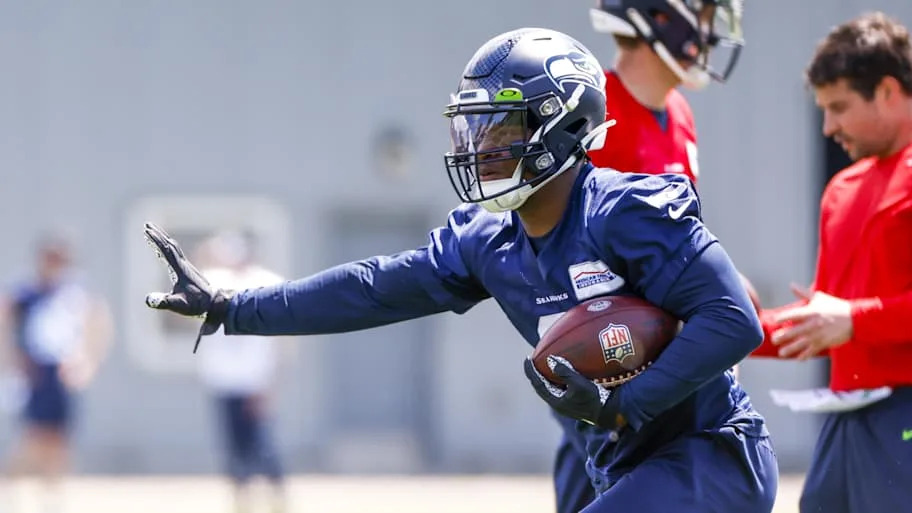 Seattle Seahawks running back Ken Walker III participates in a drill during OTA's at the Virginia Mason Athletic Center