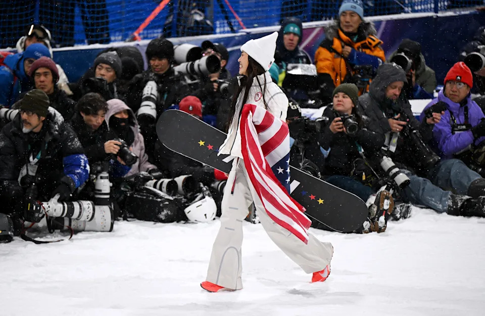 Silver medalist Chloe Kim of Team United States celebrates in front of a group of photographers.