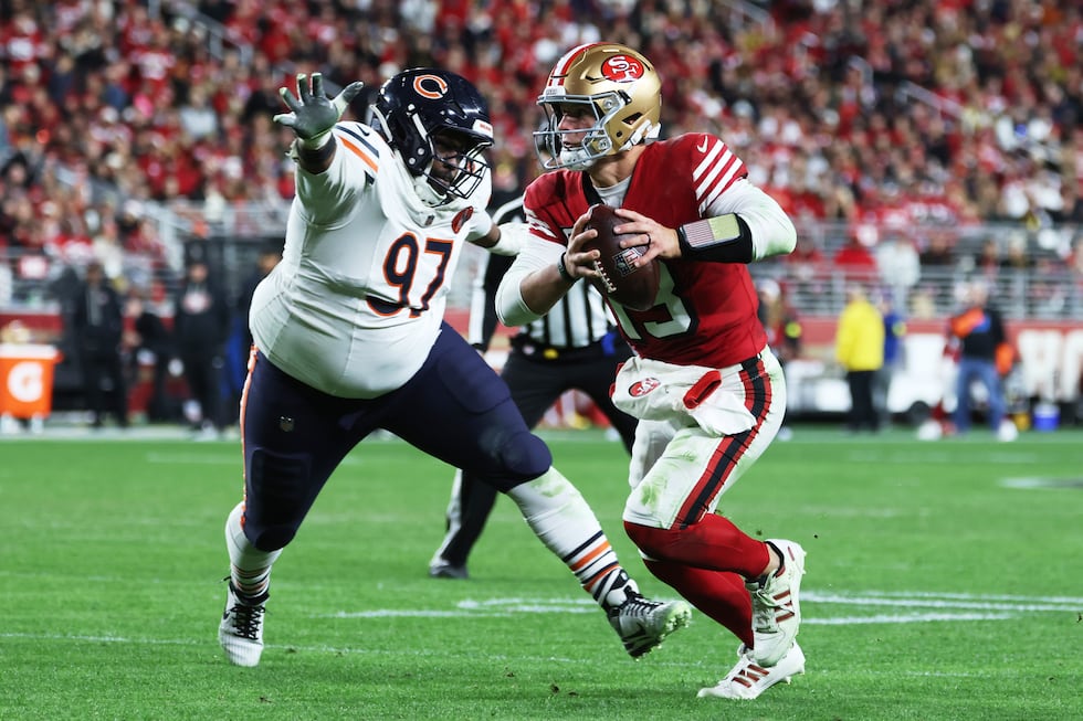 San Francisco 49ers quarterback Brock Purdy, right, scrambles away from Chicago Bears...