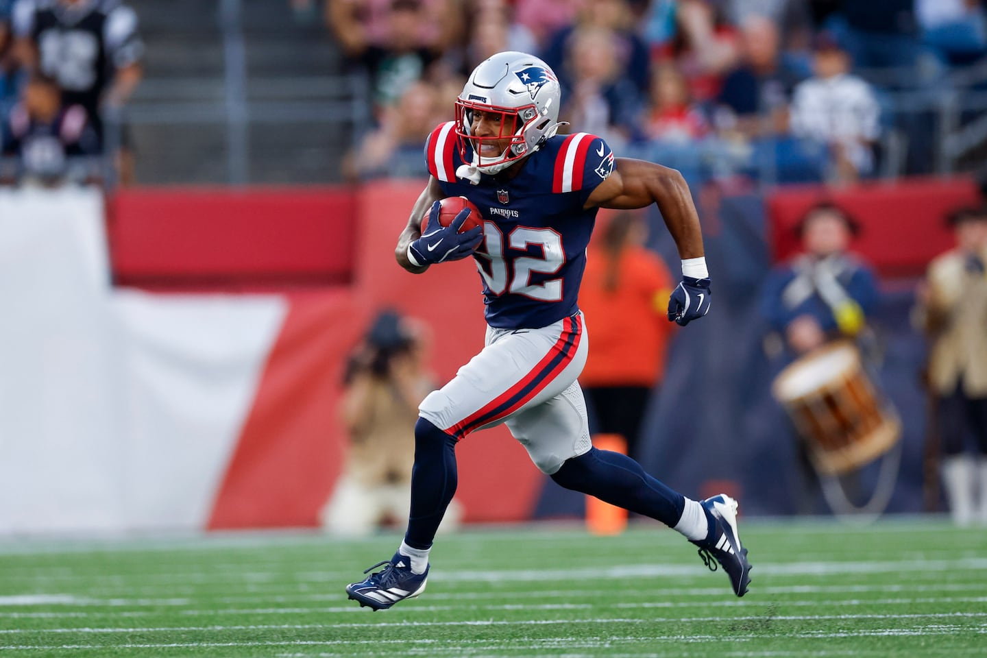 New England Patriots TreVeyon Henderson (32) carries the ball for a run back touchdown during the first half an NFL football game against the Washington Commanders, Friday, Aug. 8, 2025, in Foxborough, Mass. 