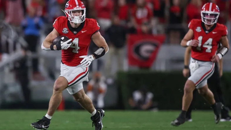 Oscar Delp runs the ball against Texas at Sanford Stadium. Vikings tight end options.