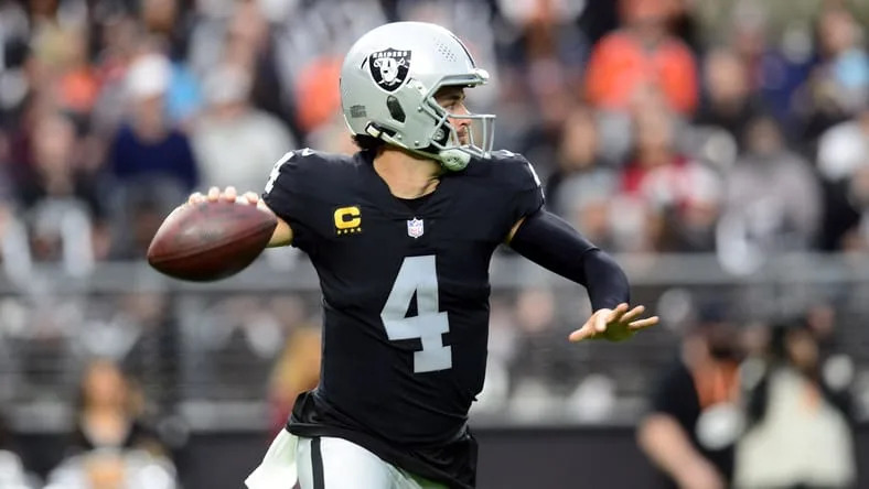 Derek Carr throws a pass during a Raiders game against the Broncos.