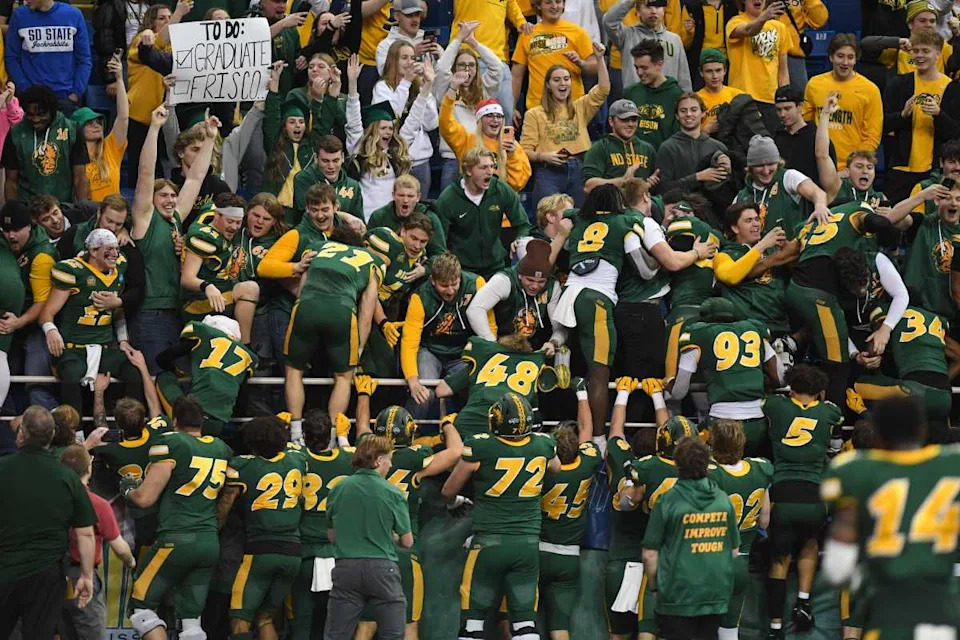 North Dakota State Bison football climbs into the student section to celebrate their win over South Dakota State Jackrabbits© Samantha Laurey &sol; Argus Leader &sol; USA TODAY NETWORK via Imagn Images