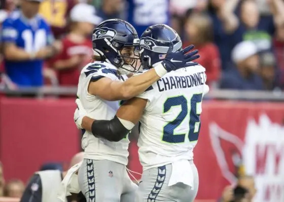 Seattle Seahawks running back Zach Charbonnet (26) celebrates a touchdown with teammate Jake Bobo against the Arizona Cardinals in the first half at State Farm Stadium on Dec 8, 2024.