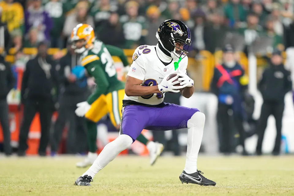 Dec 27, 2025; Green Bay, Wisconsin, USA; Baltimore Ravens tight end Isaiah Likely (80) catches a pass against the Green Bay Packers during the first quarter at Lambeau Field. Mandatory Credit: Kayla Wolf-Imagn Images