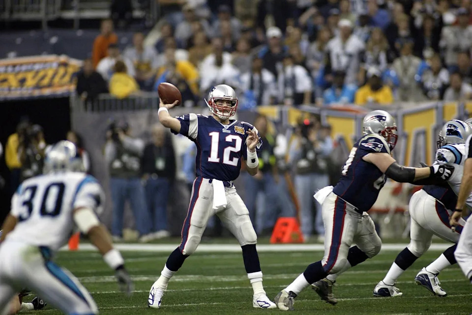Feb 1, 2004; Houston, TX, USA; FILE PHOTO; New England Patriots quarterback Tom Brady (12) throws a pass against the Carolina Panthers during Super Bowl XXXVIII at Reliant Stadium. The Patriots defeated the Panthers 32-29.